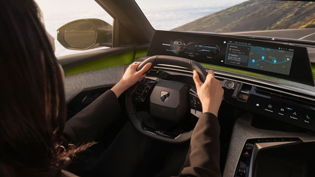 Interior of a PEUGEOT concept car with steering wheel and dashboard