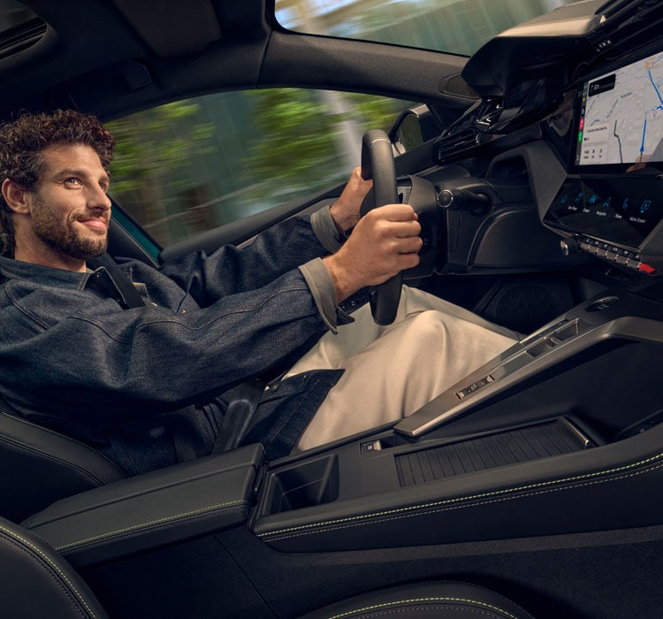 Blue Peugeot 408 fastback front view with person in yellow walking away looking back at the car